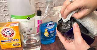 Someone using a rag to clean off sticker residue from the bottom of a starbucks cup next to some products that can be used to easily ...