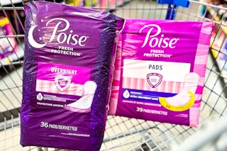 a dark purple and magenta colored package of Poise pads in a cart