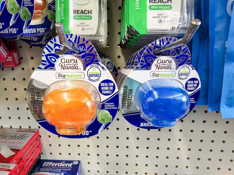 gurunanda brush pods hanging up on display