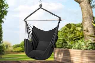 Lifestyle image of the Segmart Large Hammock Chair Swing in black hanging on a tree