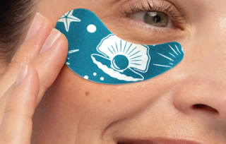 a person wearing a blue and white under-eye patch