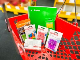 staples back to school items in a red shopping basket
