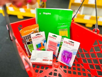 staples back to school items in a red shopping basket