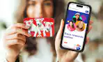 A woman holds up a Target gift card