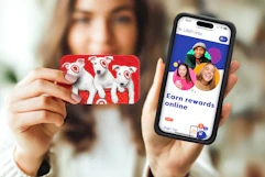 A woman holds up a Target gift card