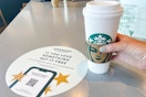 person holding a large starbucks hot beverage in store