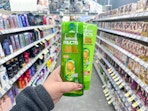hand holding garnier fructis shampoo in walgreens