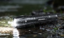 a flashlight on the ground in rain