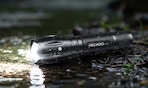 a flashlight on the ground in rain
