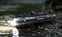 a flashlight on the ground in rain