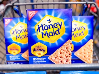 Three boxes of Honey Maid Graham Crackers in Walmart shopping cart
