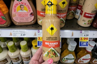 hand holding a bottle of california pizza kitchen dressing