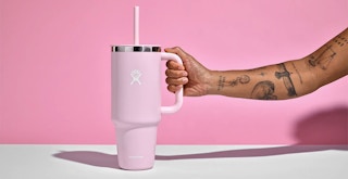 Someone grabbing the handle of a Hydro Flask All Around Travel Tumbler