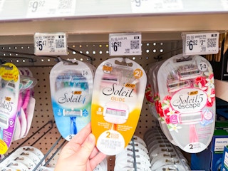 hand holding a pack of bic soleil 5 glide razors hanging at walmart