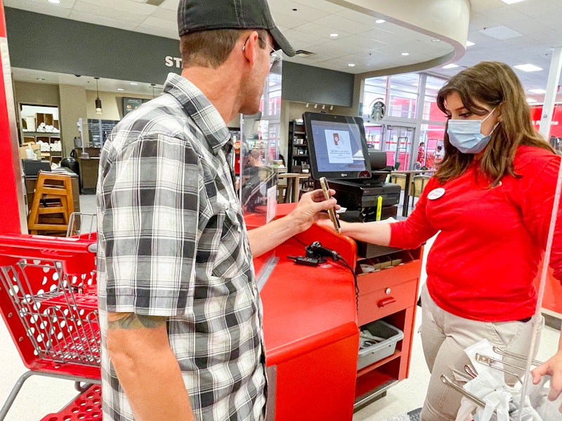 man showing cellphone to target employee