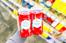 person holding 2 old spice deodorants