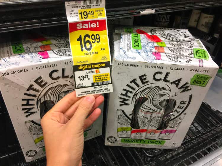 Sale and coupon promo tag for White Claw in front of two boxes of White Claw at Albertsons Tom Thumb