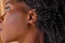 a woman wearing butterfly earrings