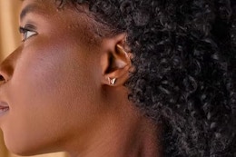 a woman wearing butterfly earrings