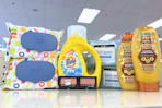garnier whole blends shampoo, neutrogena wipes, maybelline eyeshadow, tide simply, and honest wipes on a shelf