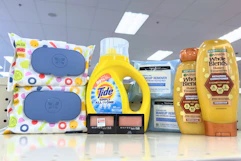 garnier whole blends shampoo, neutrogena wipes, maybelline eyeshadow, tide simply, and honest wipes on a shelf