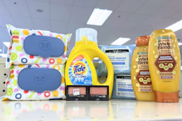 garnier whole blends shampoo, neutrogena wipes, maybelline eyeshadow, tide simply, and honest wipes on a shelf