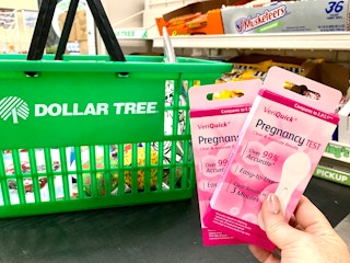 a person holding up pregnancy tests at dollar tree