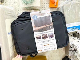 hand grabbing a clevermade laundry tote off a target shelf