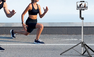 a person running in front of a tripod