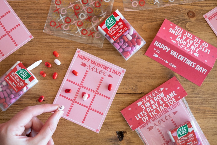 someone putting tic tacs on tic tac toe printable valentine