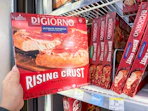 hand holding digiorno pizza in walgreens
