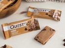 two packaged and one unpackaged protein bar on counter