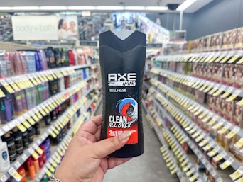 hand holding axe shampoo in walgreens