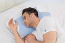 a man sleeping on a neck pillow