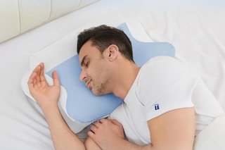 a man sleeping on a neck pillow