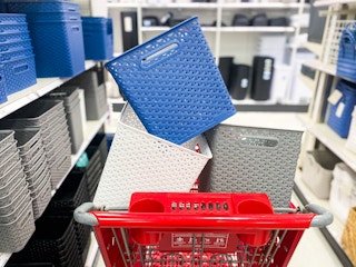 Three decorative storage items in a Target shopping cart in the storage basket aisle