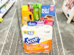 arm & hammer detergent, crest toothpaste, garnier shampoo, nutrigrain bars, and scott toilet paper in a cart