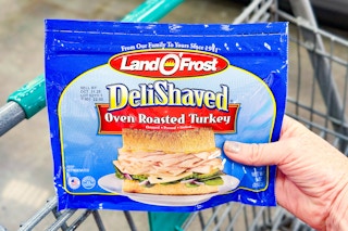 hand holding a pack of land o frost lunch meat