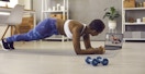 best youtube workout channels - A person watching a workout video and planking