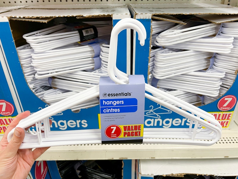 White plastic hangers in front of the two boxes filled with hangers