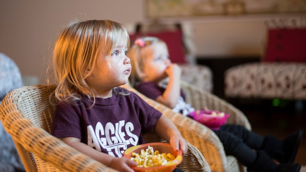 two kids in chairs with popcorn