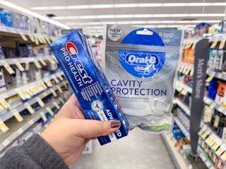 hand holding crest and oral-b products in walgreens