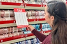a woman looking at sale pricing in the chrsitmas ribbon section