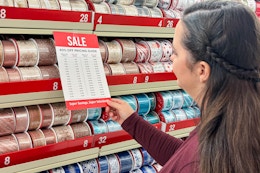 a woman looking at sale pricing in the chrsitmas ribbon section
