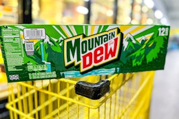 mountain dew 12-pack on top of yellow shopping cart