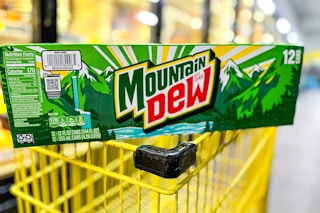 mountain dew 12-pack on top of yellow shopping cart