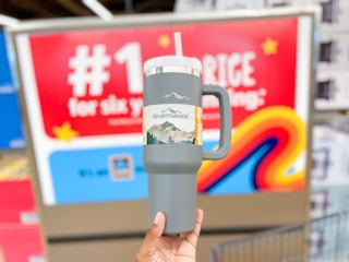 Someone holding up an Adventuridge tumbler in Aldi