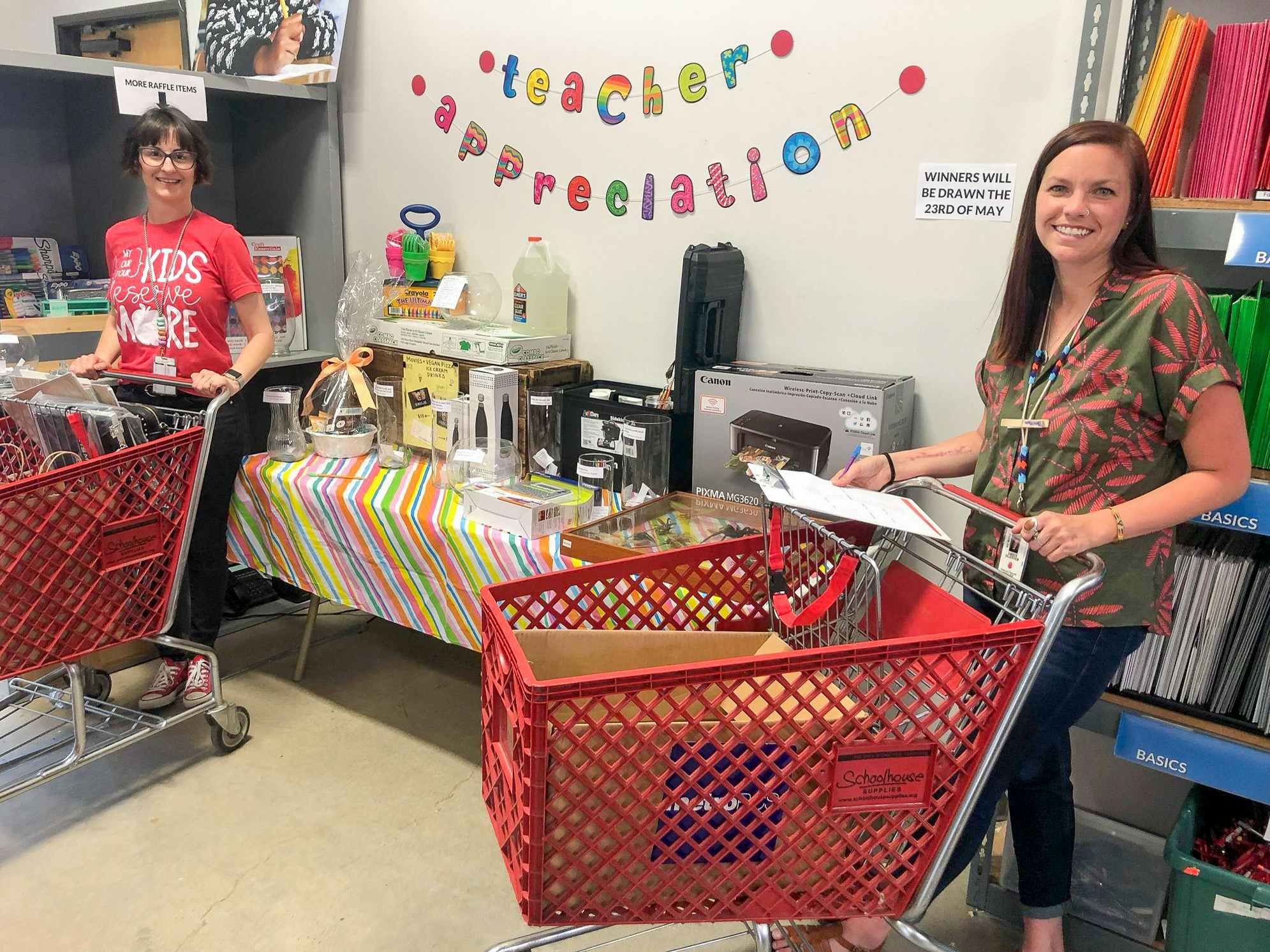 Two teachers pushing shopping carts in Schoolhouse Supplies.