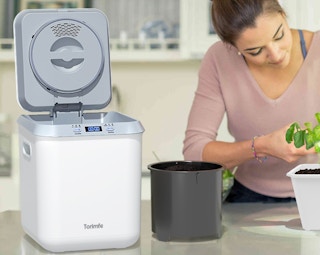 a person using a mini composter