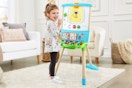 Lifestyle image of child playing with a Leapfrog Easel in living room setting